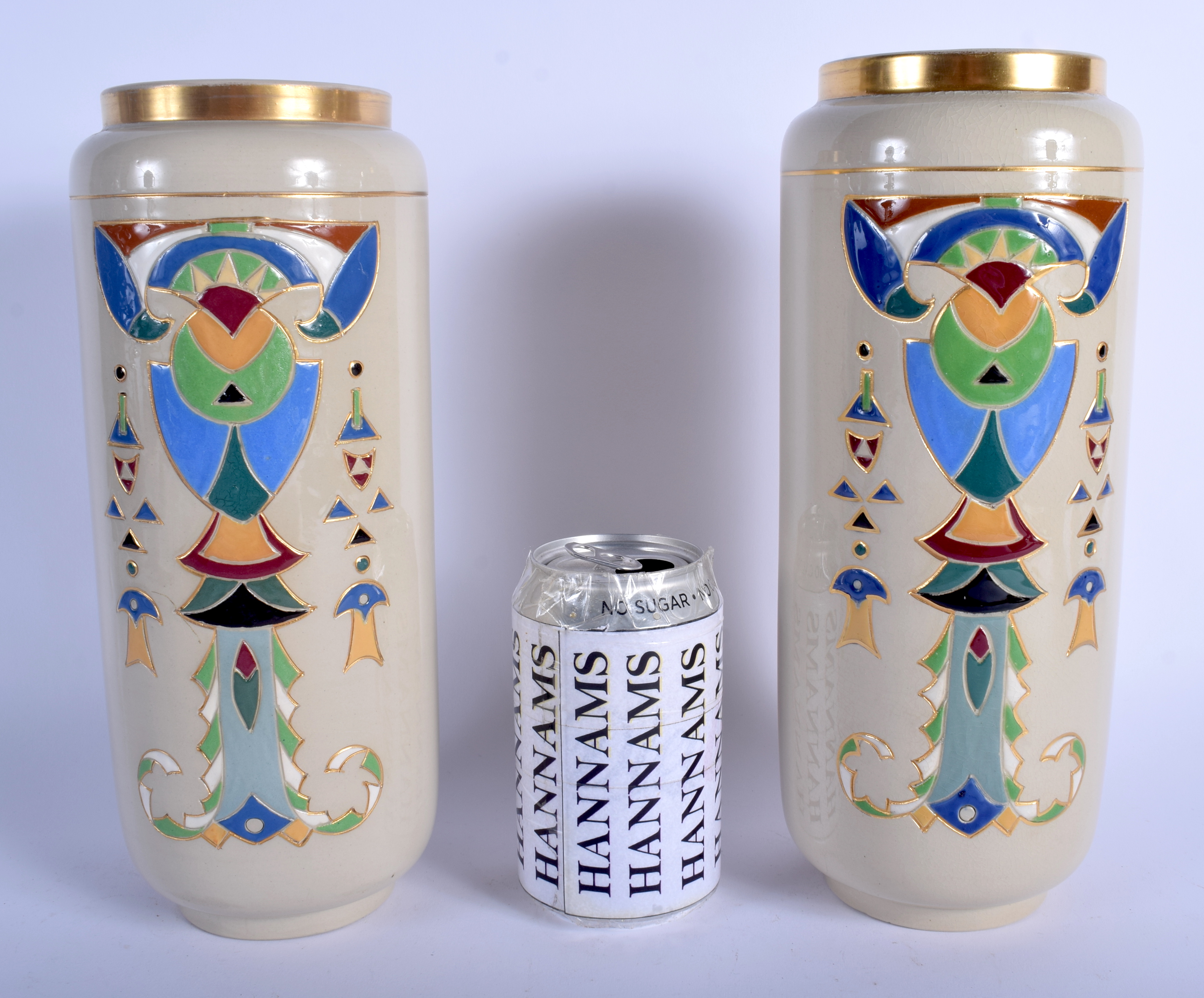 A LARGE PAIR OF ART DECO FRENCH SARREGUEMINES VASES enamelled with motifs. 27 cm high.