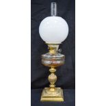 A Victorian Oil Lamp on a brass column 61 cm