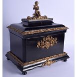 A MID 19TH CENTURY FRENCH EBONISED BRONZE CASKET modelled with a seated cherub upon a shaped base.