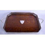 AN EDWARDIAN OAK AND SILVER PLATED SERVING TRAY. 60 cm x 34 cm.