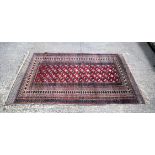 Red ground oriental rug. 188cm x 123cm