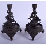 A PAIR OF 19TH CENTURY JAPANESE MEIJI PERIOD BRONZE DRAGON CANDLESTICKS upon circular bases. 18 cm