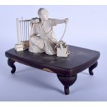 A RARE 19TH CENTURY JAPANESE MEIJI PERIOD CARVED IVORY ARCHER modelled seated beside an arrow stand