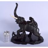 A 19TH CENTURY JAPANESE MEIJI PERIOD BRONZE OKIMONO modelled as two tigers attacking an elephant. 2