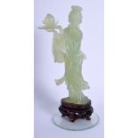 AN EARLY 20TH CENTURY CHINESE CARVED JADE FIGURE OF GUANYIN modelled holding aloft a fruit. Jade 15