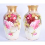 A PAIR OF ROYAL WORCESTER PORCELAIN VASES painted with pink roses. 15 cm high.
