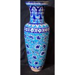a large Islamic painted terracotta vase decorated with flowers 54 x 19cm
