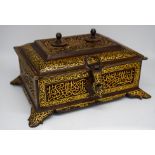 An Islamic metal gilded lidded box with open work and swirling floral patterns 18cm