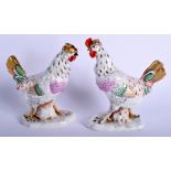 A PAIR OF EARLY 20TH CENTURY GERMAN PORCELAIN BIRDS modelled upon a naturalistic base. 17 cm x 10 c