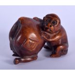 A CONTEMPORARY JAPANESE BOXWOOD OKIMONO modelled as a monkey and peach. 5.5 cm wide.