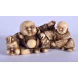 A 19TH CENTURY JAPANESE MEIJI PERIOD CARVED IVORY NETSUKE modelled as a buddha and boy. 5 cm x 2.5