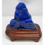 A Lapis lazuli carved boulder with stand 12 x 12 cm
