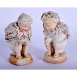 A RARE PAIR OF ANTIQUE GERMAN PORCELAIN FIGURES modelled defecating into mugs. 7.5 cm high.