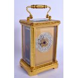 AN EARLY 20TH CENTURY FRENCH BRASS CARRIAGE CLOCK with silvered dial. 14 cm high inc handle.