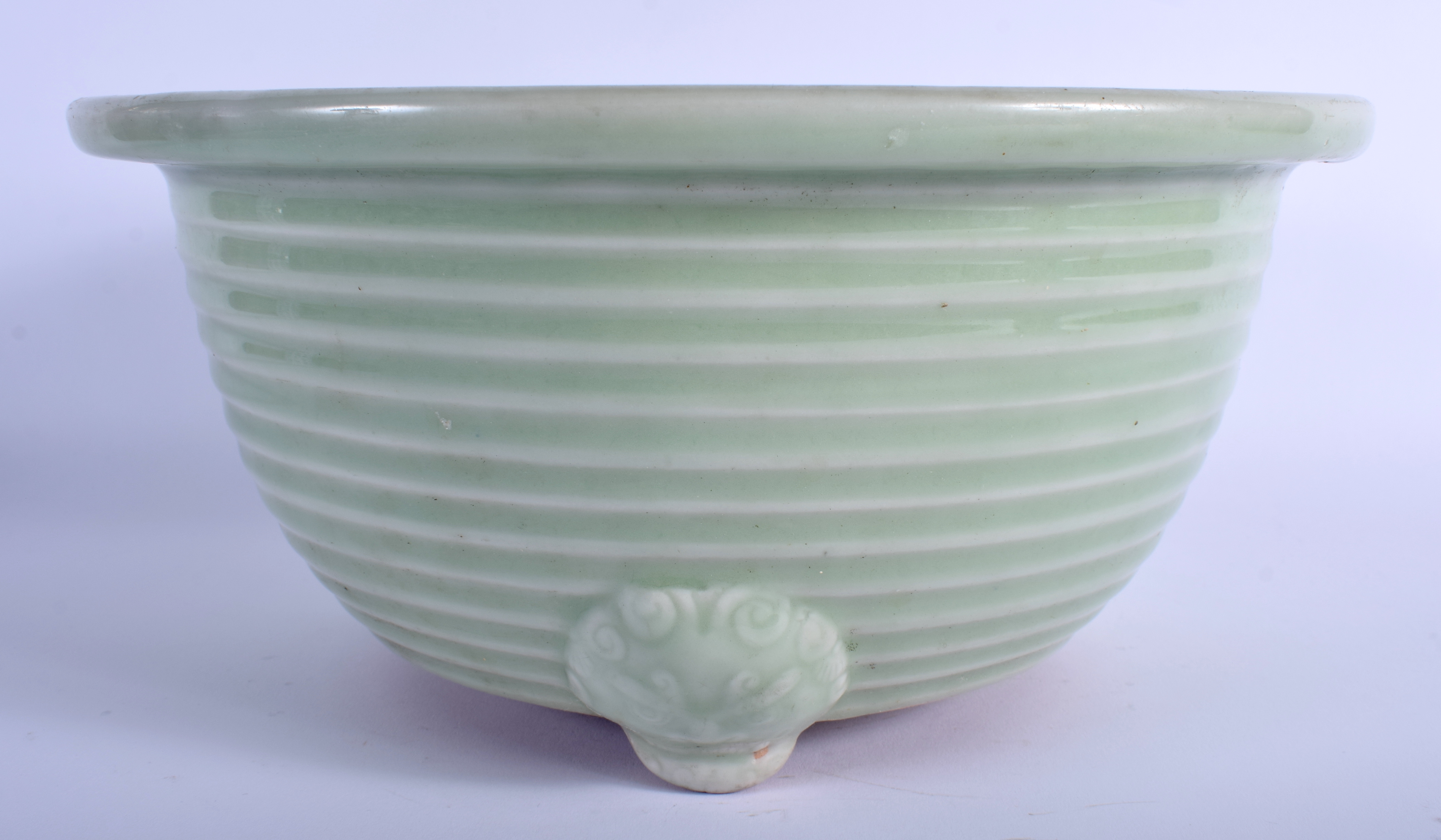 A LARGE 19TH CENTURY CHINESE CELADON RIBBED CENSER Qing, with highly unusual mask head mounts. 26 c