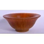 A CHINESE CARVED BUFFALO HORN TYPE LIBATION CUP. 13 cm diameter.