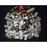 A collection of military badges and tunic buttons