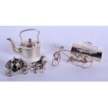 A NOVELTY SILVER TEAPOT AND COVER together with two silver carriages. 177 grams. (3)