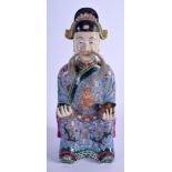 A 19TH CENTURY CHINESE FAMILLE ROSE PORCELAIN FIGURE OF AN IMMORTAL Late Qing, painted with dragons