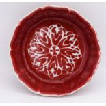 A Chinese Ming copper red scalloped bowl