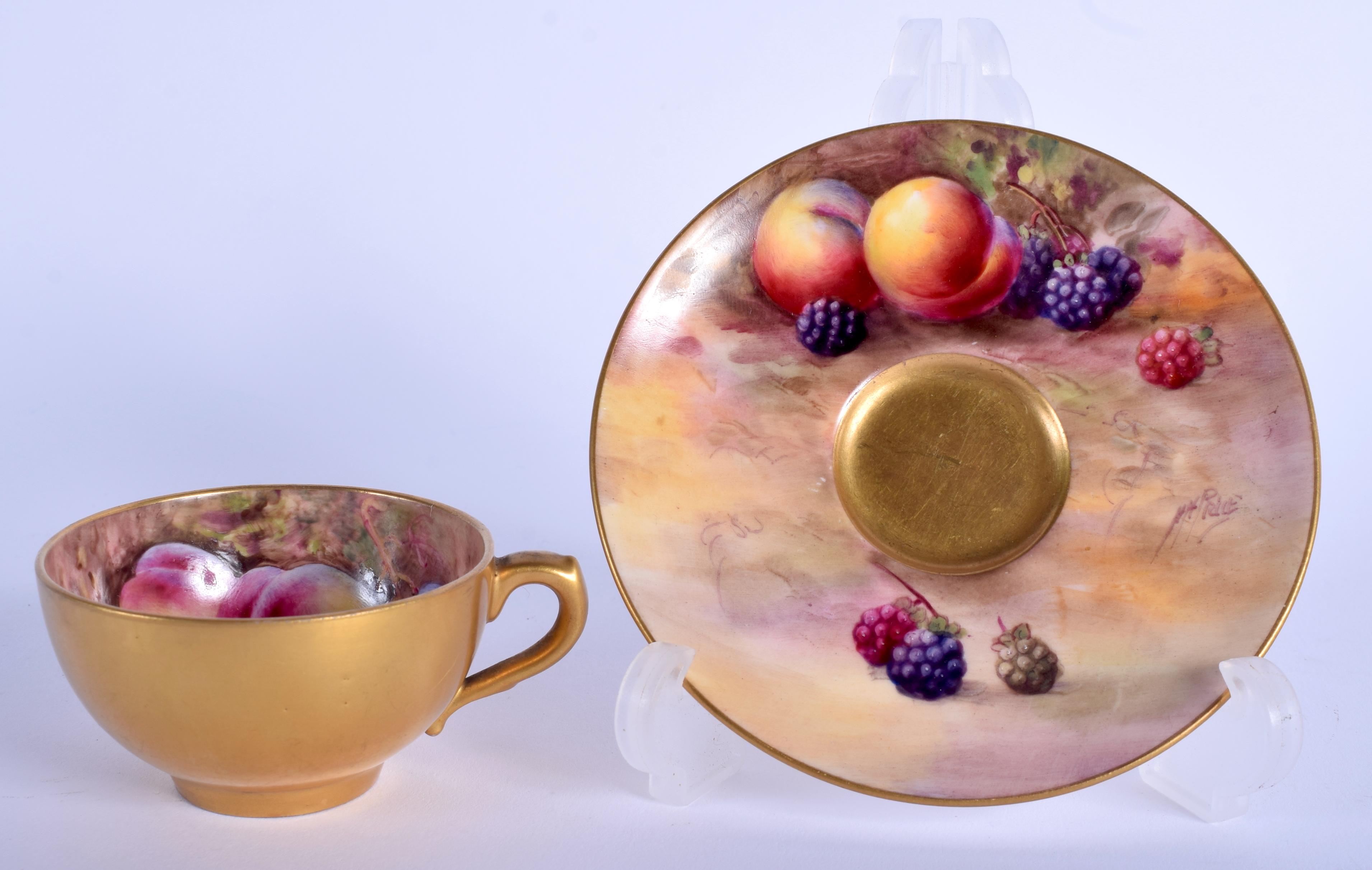 A ROYAL WORCESTER FRUIT PAINTED CUP AND SAUCER by Hale & Price. (2)