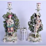 Derby pair patch mark candlestick figures of the Italian Farmer and Wife. 33Cm high