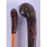 AN EARLY 20TH CENTURY TWIST WALKING CANE together with another similar. 84 cm long. (2)