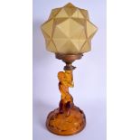 AN ART DECO AMBER GLASS FIGURAL LAMP with facetted form. 40 cm x 11 cm.