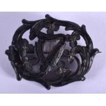 A 19TH CENTURY IRISH CARVED BOG OAK HARP BROOCH. 5.5 cm x 3.5 cm.