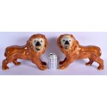 A LARGE PAIR OF 19TH CENTURY CONTINENTAL POTTERY FIGURES OF LIONS. 34 cm x 28 cm.