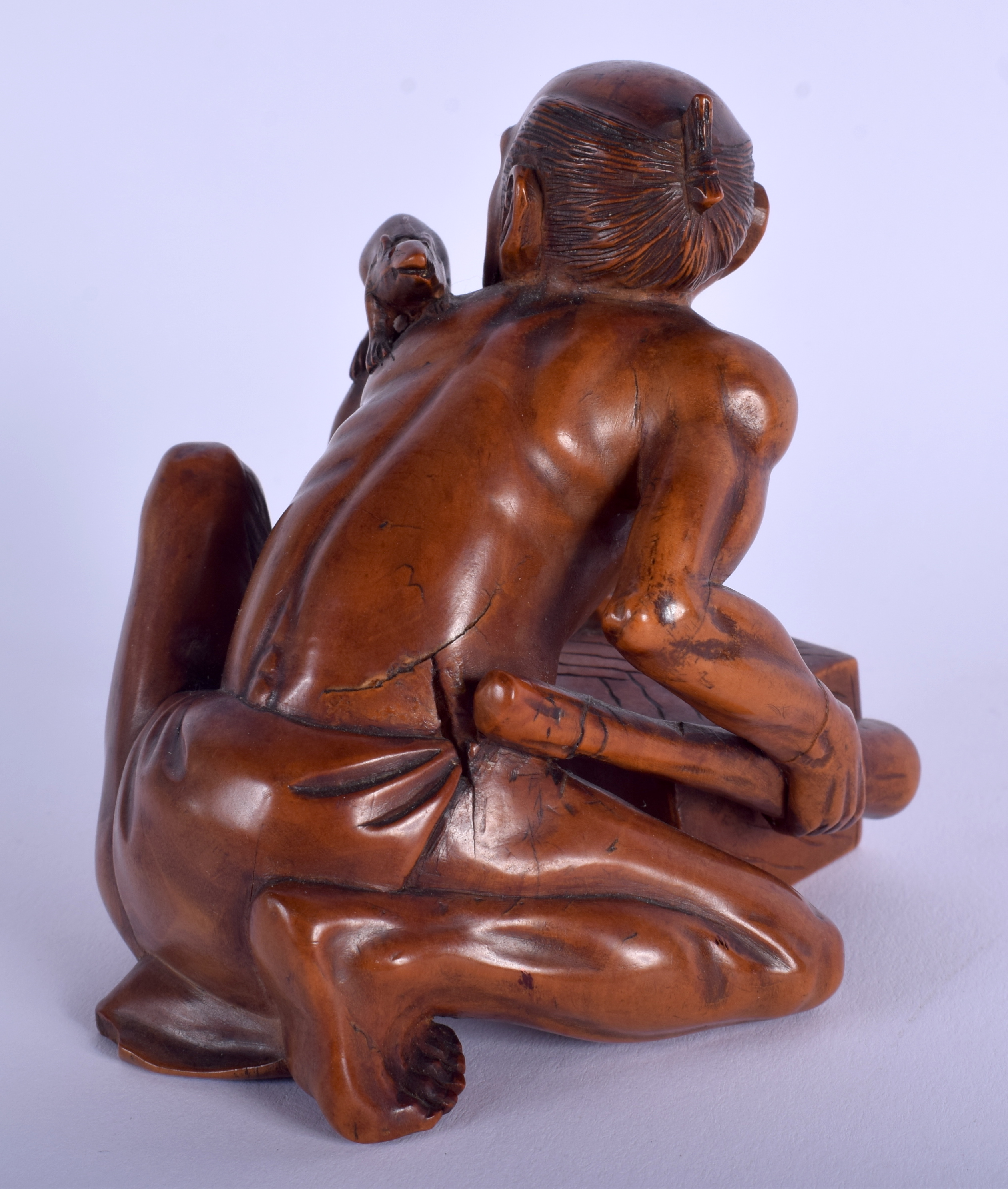A 19TH CENTURY JAPANESE MEIJI PERIOD CARVED BOXWOOD RAT CATCHER modelled scowling upon an upturned - Image 2 of 3