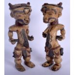 A PAIR OF EARLY 20TH CENTURY AFRICAN PAINTED TRIBAL FIGURES painted with motifs. 25 cm x 8 cm.