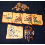 A collection of wooden items including a wooden dog, hanging plaques