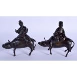 A PAIR OF 19TH CENTURY CHINESE SILVER INLAID BRONZE FIGURES modelled as scholars upon buffalos. 15