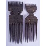 A PAIR OF EARLY 20TH CENTURY TRIBAL COMBS decorated with motifs. 18.5 cm long.
