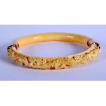 A 19TH CENTURY CHINESE CARVED IVORY DRAGON BANGLE Qing. 8.5 cm diameter.