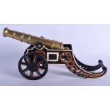 AN ANTIQUE BRONZE SIGNAL CANNON upon a painted cast iron base. 42 cm wide.