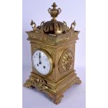 A 19TH CENTURY FRENCH BRASS MANTEL CLOCK with bold circular dial, within a case decorated with cher