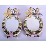 19th c. Sitzendorf pair of table mirrors surmounted by winged cherubs. 17cm high