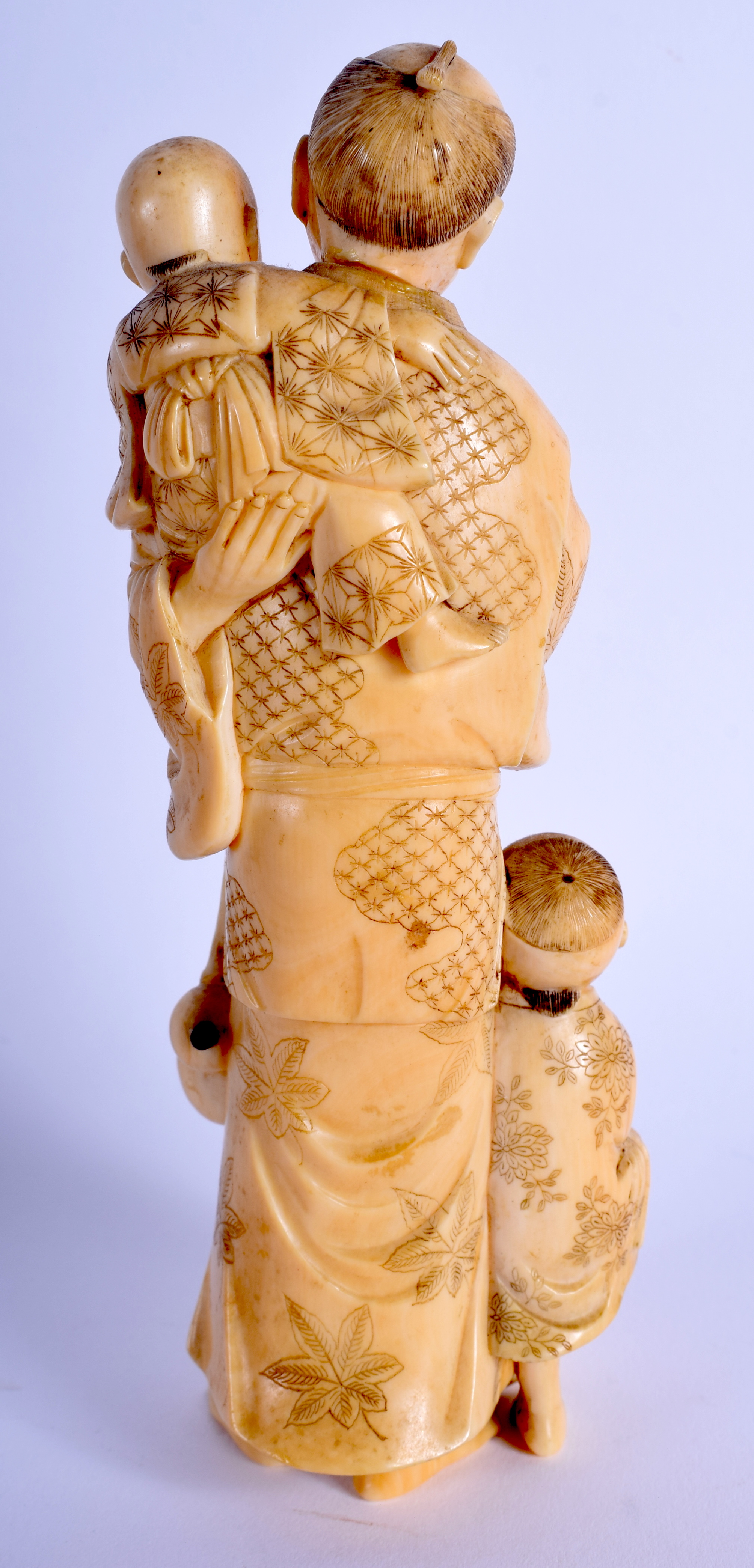 A 19TH CENTURY JAPANESE MEIJI PERIOD CARVED IVORY OKIMONO modelled as a male and two children holdi - Image 2 of 3