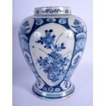 AN 18TH CENTURY DUTCH BLUE AND WHITE TIN GLAZED VASE painted with flowers. 24 cm high.