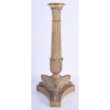 A 19TH CENTURY FRENCH BRONZE FIGURE OF A CANDLESTICK modelled upon a triangular base. 36 cm high.