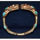 A Chinese Tibetan gilt metal dragon bangle, Turquoise stones 7.5 cm x 7cm