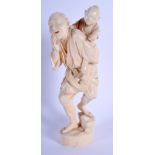 A 19TH CENTURY JAPANESE MEIJI PERIOD CARVED IVORY OKIMONO modelled as a father and child. 21 cm hig