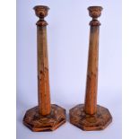 A PAIR OF EUROPEAN ART DECO PAINTED WOODEN CANDLESTICKS of angular design. 31 cm high.