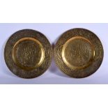 A PAIR OF 19TH CENTURY CHINESE BRONZE DISHES decorated with figures and dragons. 25 cm diameter.