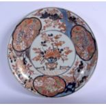AN 18TH CENTURY JAPANESE EDO PERIOD IMARI DISH painted with flowers and Buddhistic lions. 28 cm dia