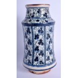 A MIDDLE EASTERN ISLAMIC BLUE AND WHITE ALBERELLO FAIENCE JAR painted with flowers. 19 cm high.