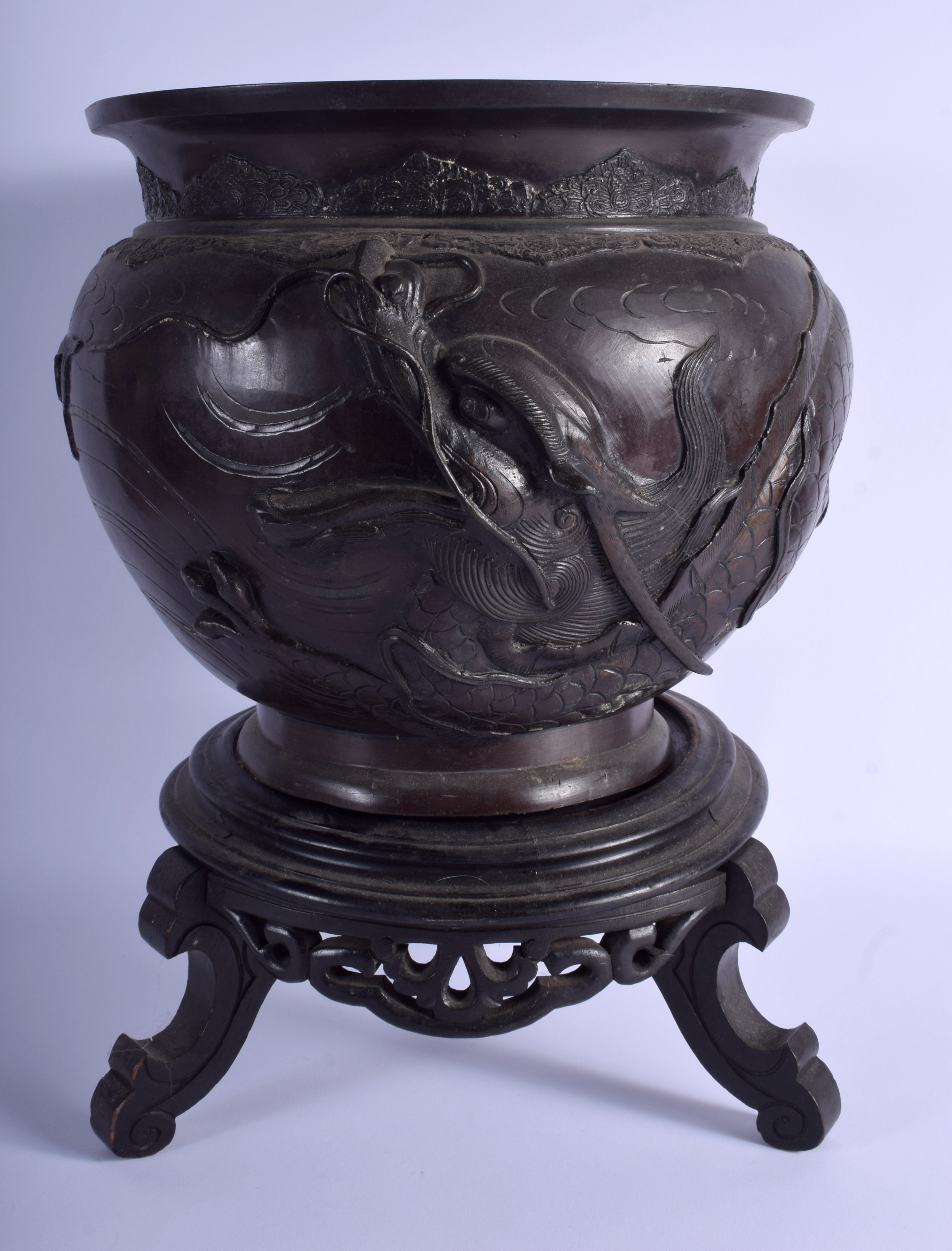 A 19TH CENTURY JAPANESE MEIJI PERIOD BRONZE JARDINIERE decorated with dragons. 27 cm x 21 cm.