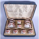 AN ANTIQUE ROYAL CROWN DERBY IMARI CUPS AND SAUCER within a fitted case. (12)